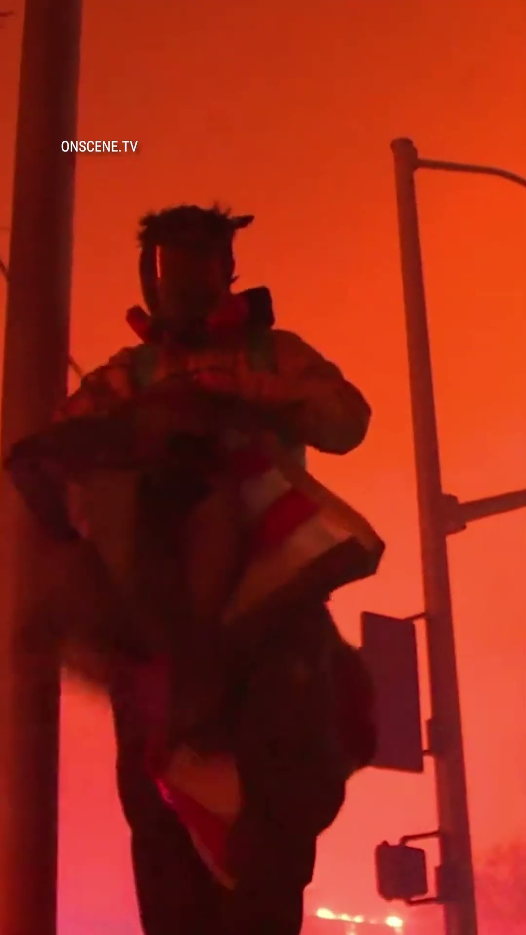 A firefighter braves the California wildfires to save an American flag about to be burned