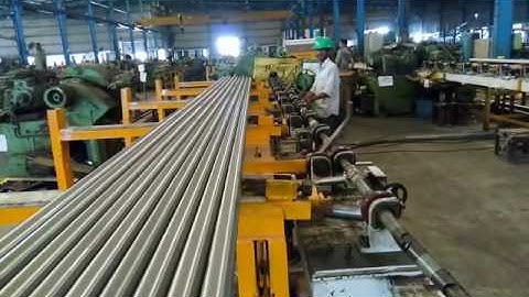 Automated loading and unloading of bright bar for center-less Grinder