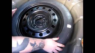 How to stow the spare tire and jack in a 2005 Ford Focus