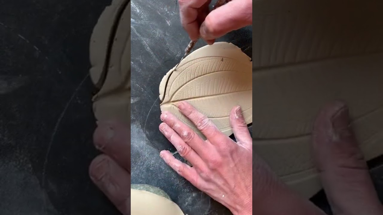 A ceramic dish using a real leaf blue glaze real gold accents 