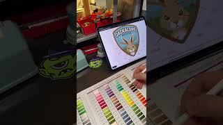 Reviewing embroidered patch thread colors for a new patch design.