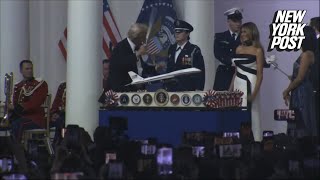 Donald Trump dances with sword after cutting cake at inaugural ball