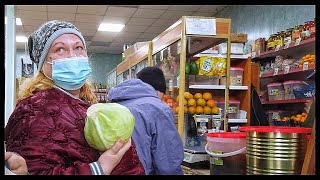 Russia, St. Petersburg: Simple village shop with Russian customers and non-Russian sellers. Walking