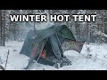 Winter car camping with stove near small pond (hot tent)