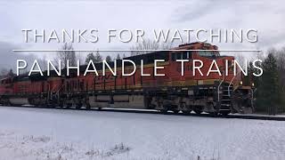 A couple of BNSF trains makes their way along Highway 95, north of Sandpoint, Idaho.