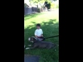 Weird kid playing with pitbull