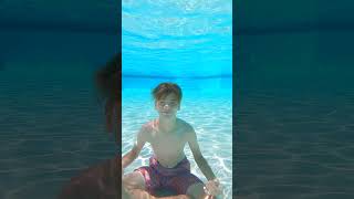 A Boy Sitting Underwater Vlog Lab