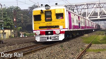 Three EMU local trains made back to back crossing in a foggy morning then another three