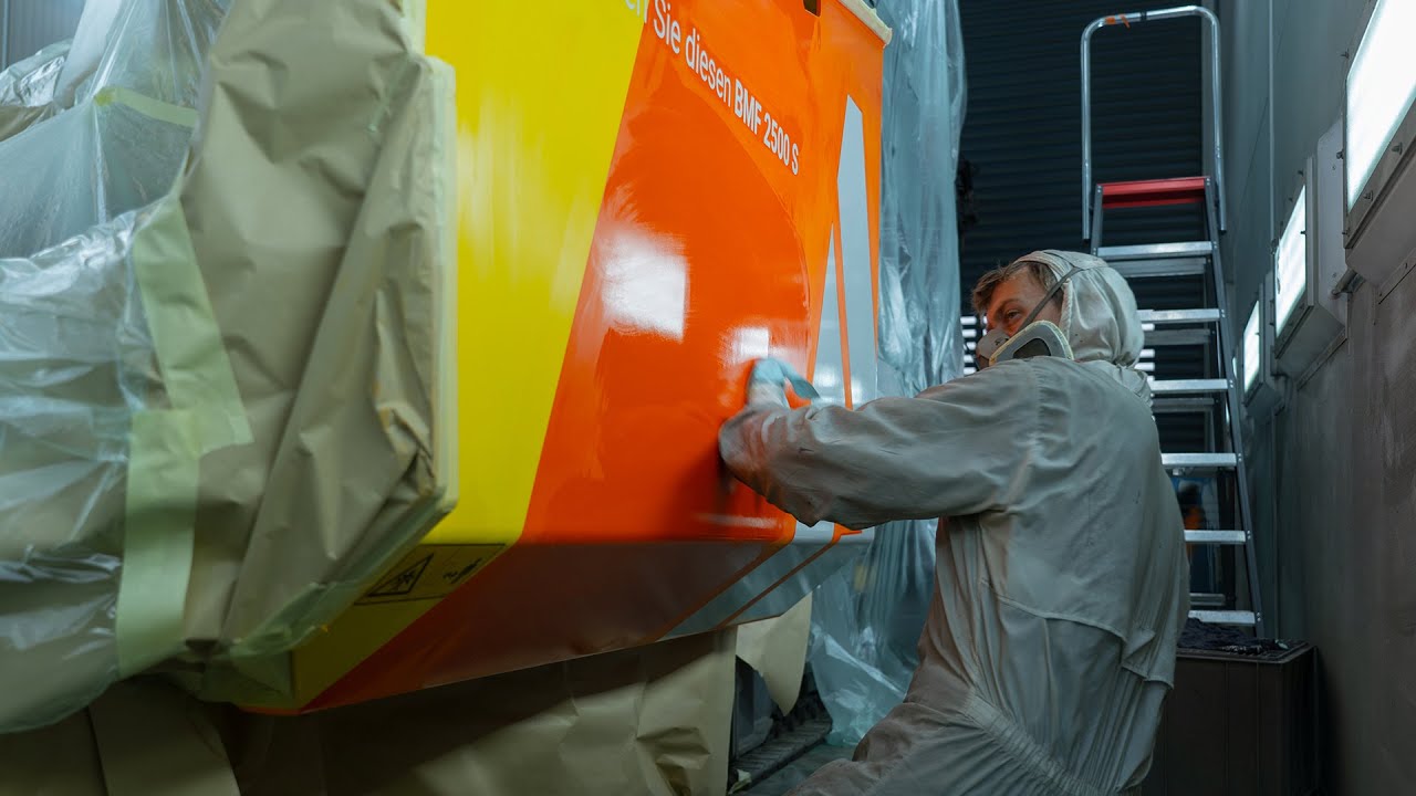 Experts spray painting heavy machinery - ALTCON Equipment