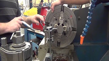 Students dial a part in a four jaw chuck.