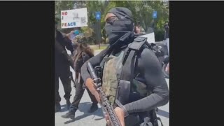 Armed militia marches outside Brunswick murder suspect's home