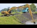 Long arm excavator digging the river canal cat 320d l komatsu pc200
