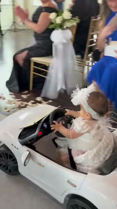 9-month-old flower girl drives down wedding aisle