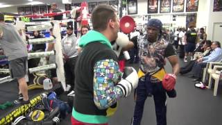 Floyd Mayweather Sr. padwork with gym visitor