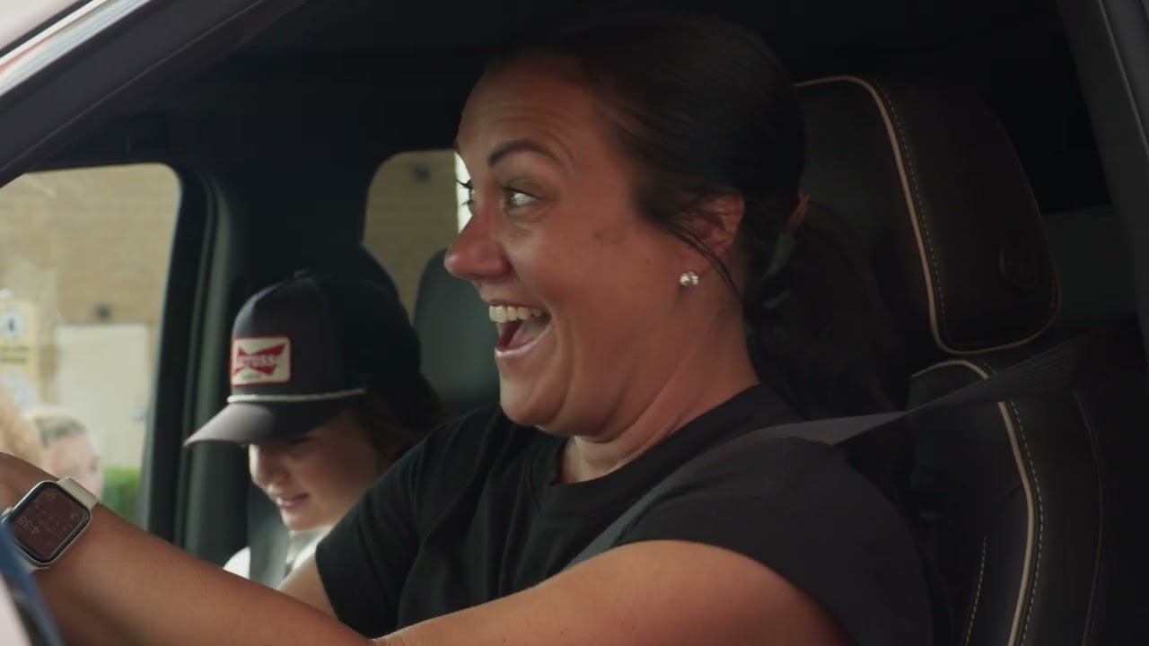 A woman cheering from a car in Round-Up, Party Down