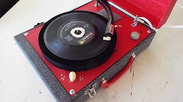 Symphonic portable record player playing a 45 RPM record.