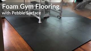Foam Gym Flooring with Pebble Surface Texture - If you're looking for an affordable, lightweight and easy to install home gym flooring, you'll want to consider interlocking foam tiles. One of the best foam gym flooring tiles is Greatmats Home Gym Flooring Tile Pebble 3/8 Inch x 2x2 Ft.
This tile is durable enough for use under exercise equipment and weighs less than 2 pounds per tile. It even comes in gray and black color options. 
The puzzle style interlocking design makes DIY installation a simple process. And the waterproof nature of the closed cell EVA foam material makes it a great fit for damp areas such as basements or garages. You can also install it over hardwood, tile, laminate, vinyl and virtually any other hard, flat surface.