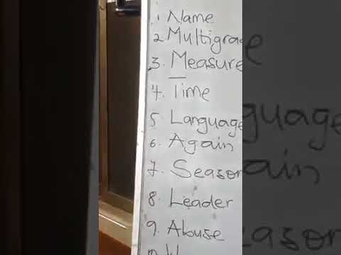 african teacher teaching english to her student
