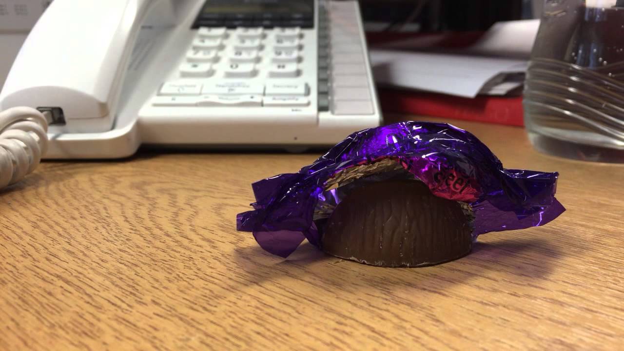 Wrapping a Cadbury roses purple one - YouTube