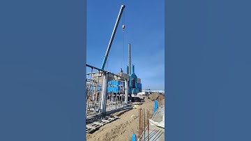Technical add concrete blocks on robot machine to driving spun pile