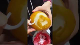 Peeling a Whole Fresh Pear Manually with a Curved Plastic Peeler Tool Indoors