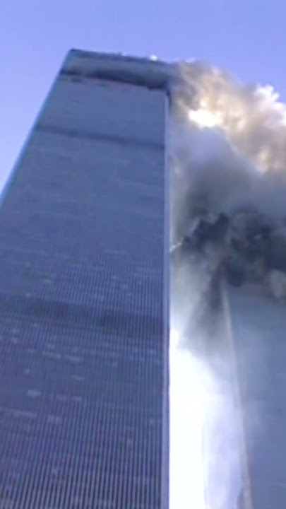 Reporter on camera as tower begins to collapse