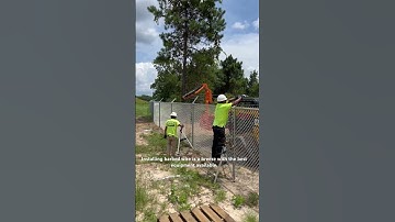 Barbed wire installation on a commercial chainlink fence.