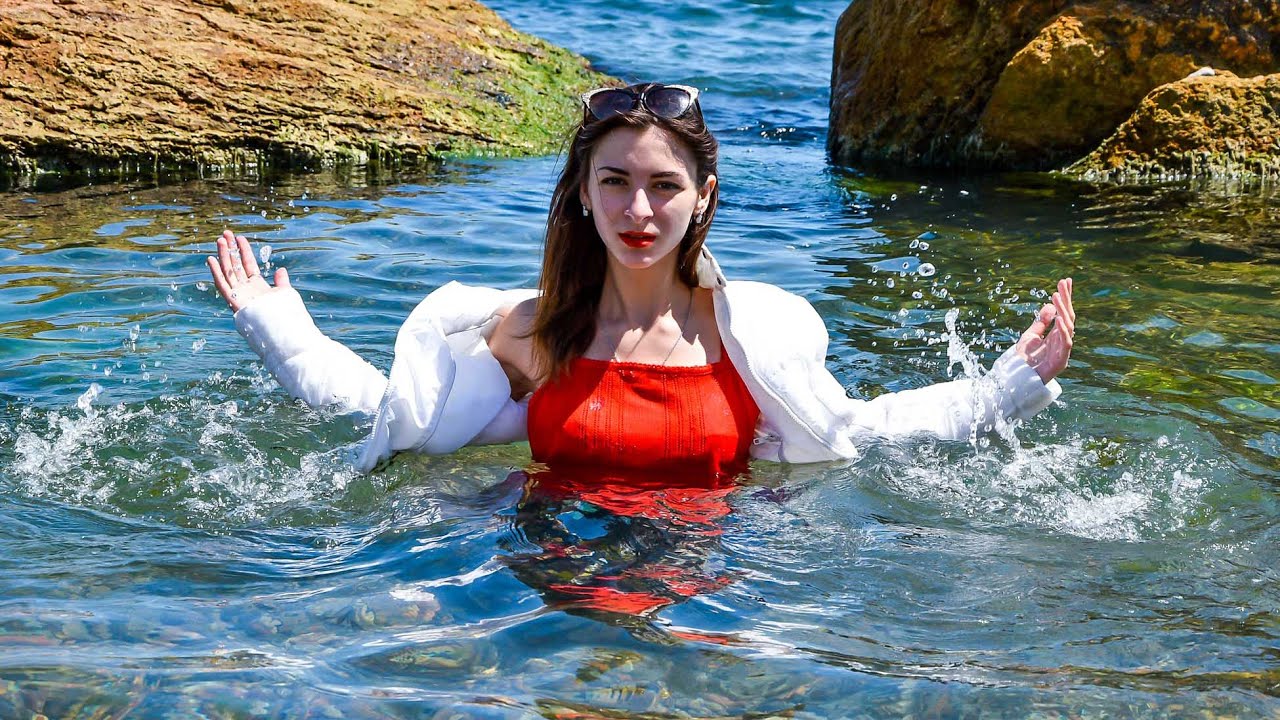 THIS IS SO COOL! A BEAUTIFUL MODEL IN A WARM WET JACKET AND WET JEANS POSES GENTLY FOR WETLOOK VIDEO