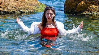 This Is So Cool A Beautiful Model In A Warm Wet Jacket And Wet Jeans Poses Gently For Wetlook Video