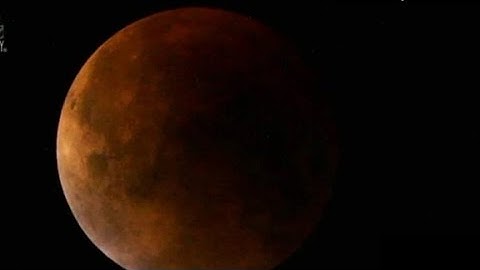 Supermoon lunar eclipse seen above Earth