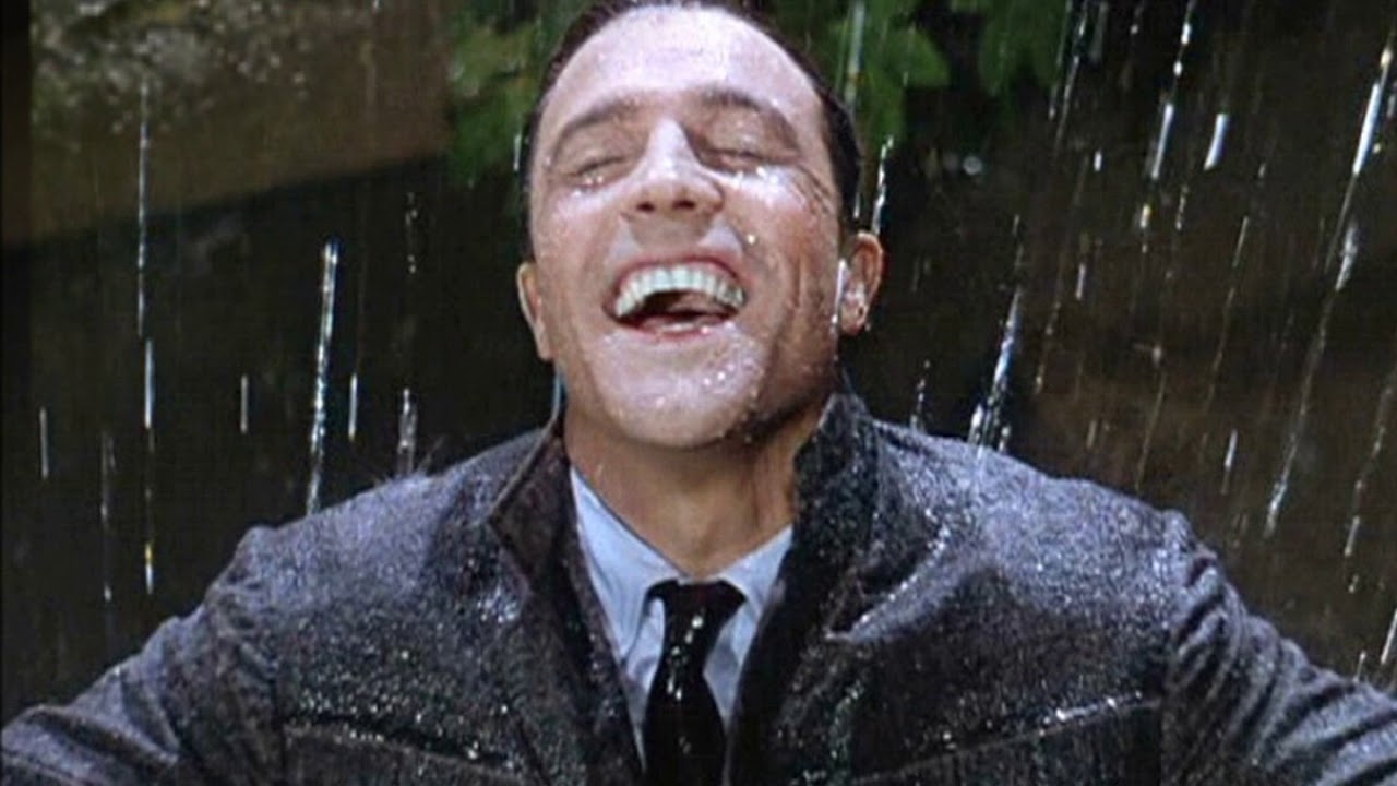 Пенья дождя. Singin’ in the Rain Джин Келли. Мужчина радуется дождю. Улыбается под дождем.