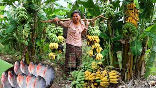 Woman picking rip banana for dogs - Cooking Fish for three dogs - Survival Skills E2