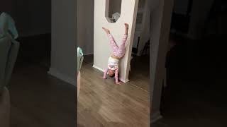 Jasmine doing a splits handstand