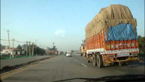 Dangerous driving in India, overtaking trucks on highway at breakneck speed