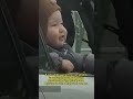 A cute child opened the car window to watch snowflakes dancing through the sky.