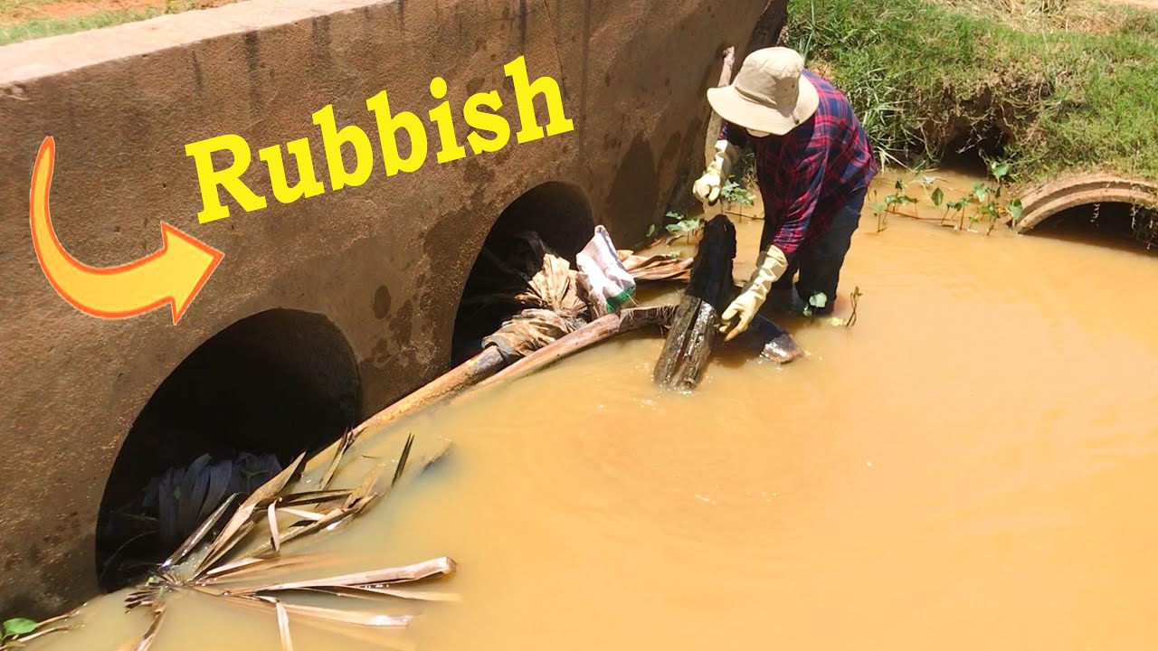 Unclogging 2 Culverts With Much Rubbish Stuck In Drain Hole - YouTube