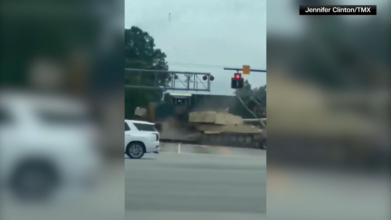 Video of the Day: Train crashes into truck and armored vehicle - YouTube