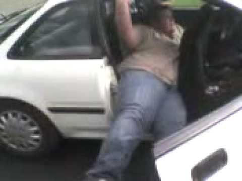 Fat guy trying to get out of a car