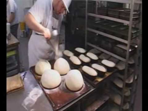 Bakerman is baking bread - a master baker at work