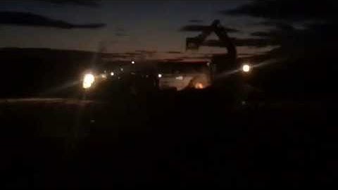 JCB Excavator loading claas and dung spreader near Castle douglas Rugby Club