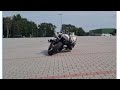 track motorcycle knee down / body position practice in a parking lot