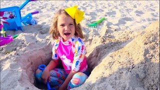 Max and Katy Playing on the beach with Daddy