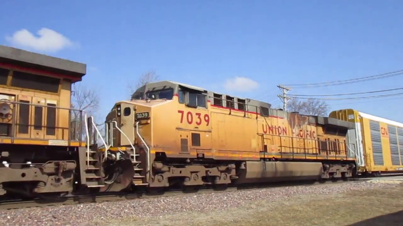 UP 6448 leads fireburned AC4460CW on WB autorack