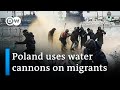 Polish security forces use water cannons in clash with migrants | DW News