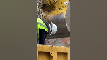 Excavator moving precast blocks