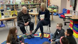 Superintendent Krestin Bahr and beloved advocate Hugh McMillan have story time with Purdy Elementary