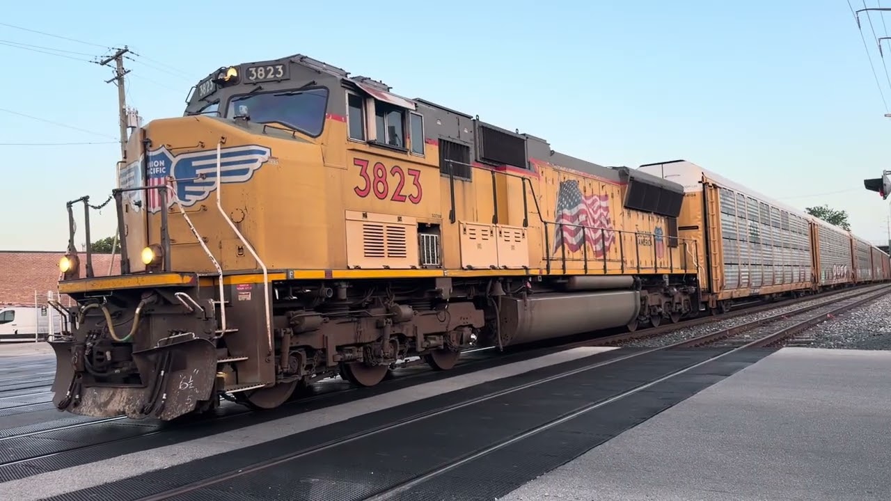 UP SD70M Leads Solo On The UP Gibson Train With Flagging Crossing
