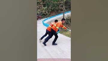 Busy Roadside Construction: Two People Lift the Guardrail Efficiently!
