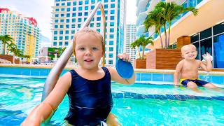 Little Naomi is enjoying the pool with her baby brother.