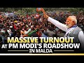 Pm modi waves at massive crowd as he holds a roadshow in malda